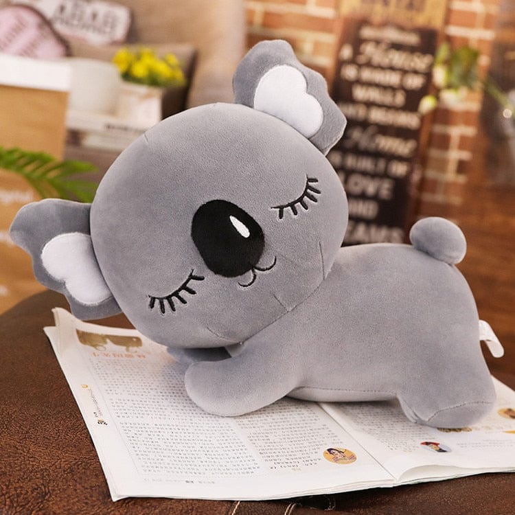 Peluche koala endormi avec de longs cils