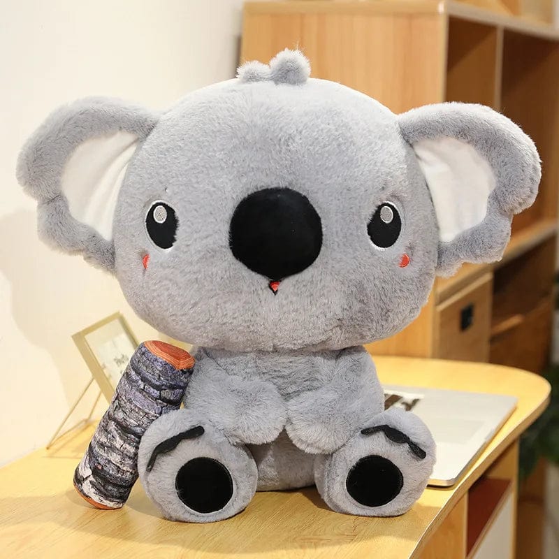 Peluche koala qui câline son bois