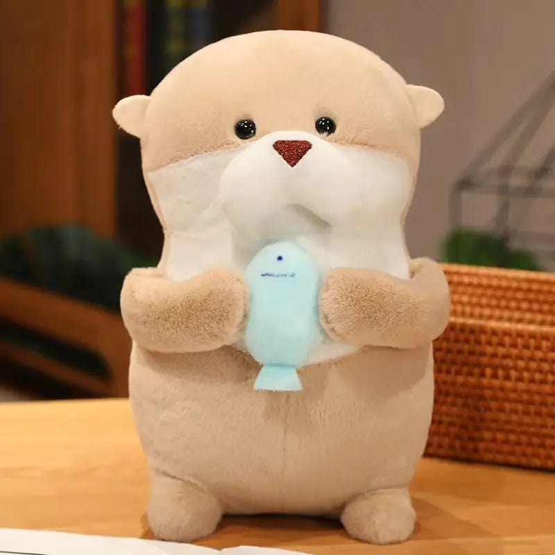 Peluche loutre tenant un poisson