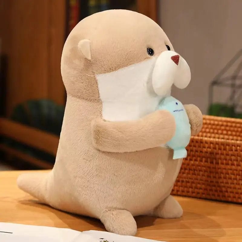 Peluche loutre tenant un poisson