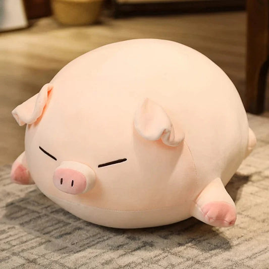 Peluche cochon allongé aux yeux fermés