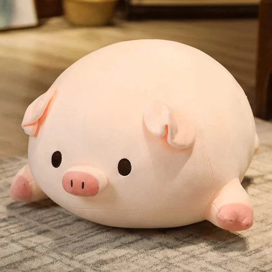 Peluche cochon allongé aux yeux ouverts