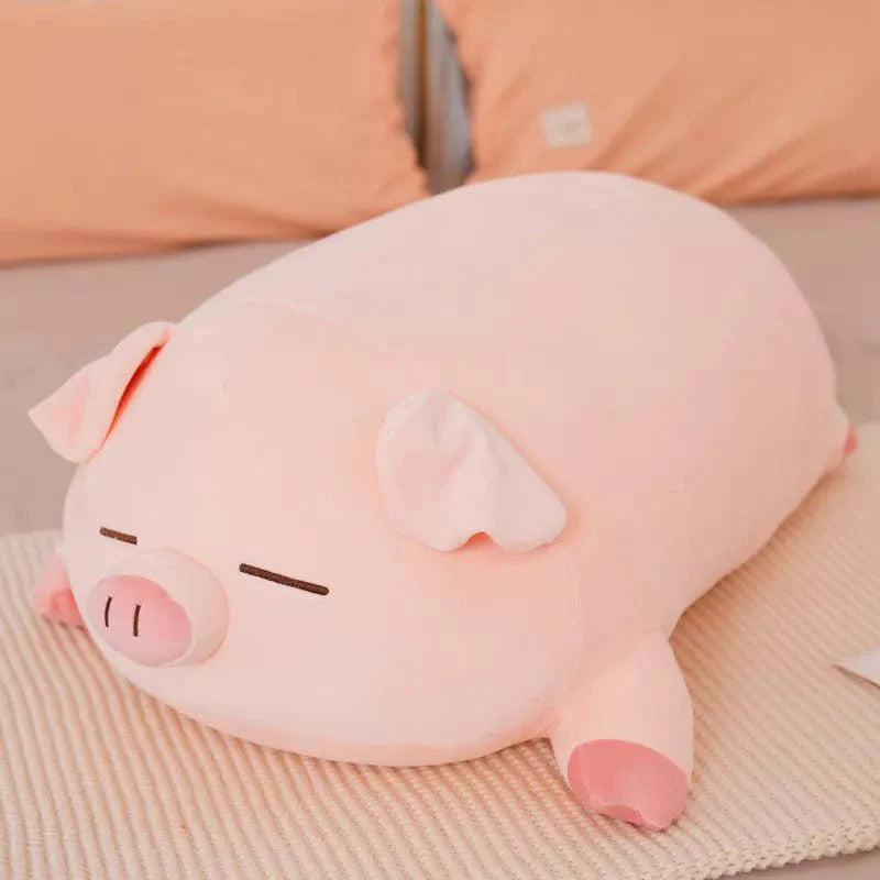 Peluche cochon rose allongé qui dort
