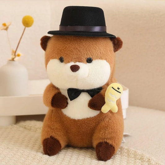 Peluche loutre avec un chapeau qui tient un poisson coloré