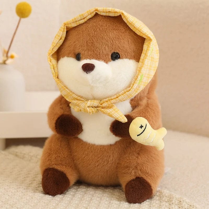 Peluche loutre avec un voile qui tient un poisson coloré