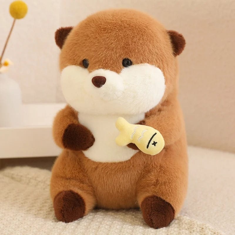 Peluche loutre avec un voile qui tient un poisson coloré