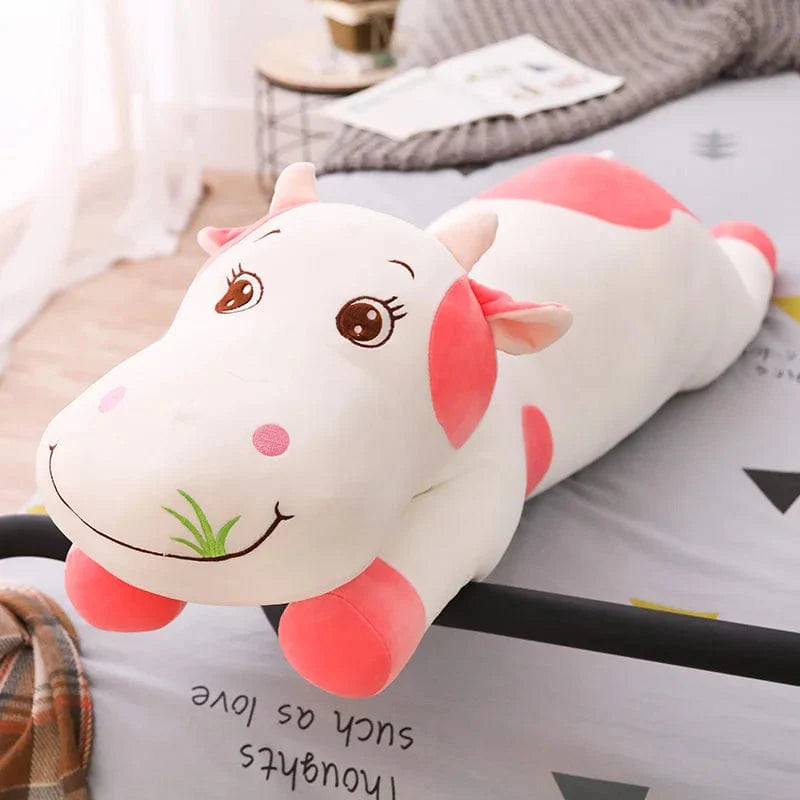 Peluche vache coloré qui broute de l'herbe